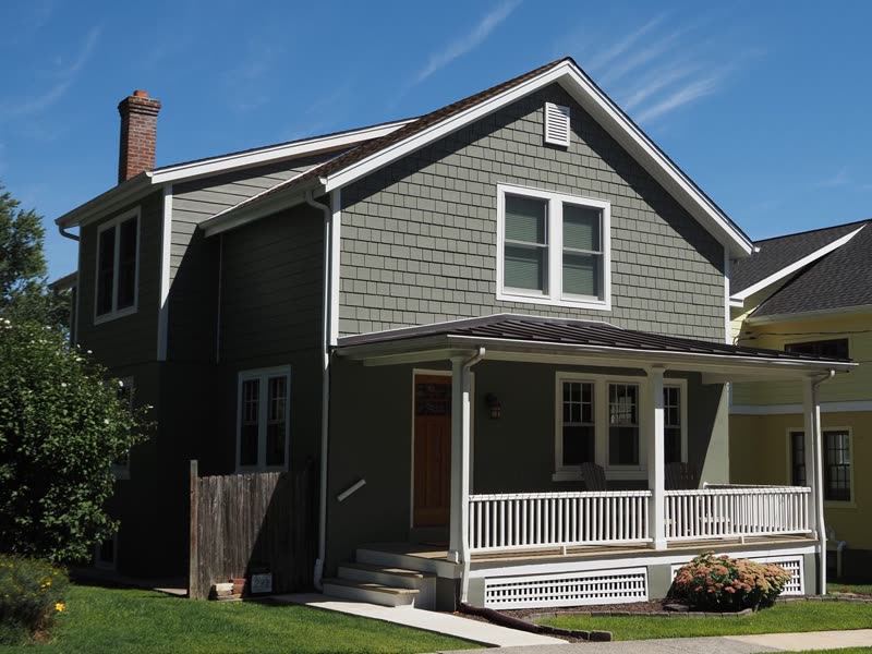 Two-storey house with grey lap siding and a covered front porch